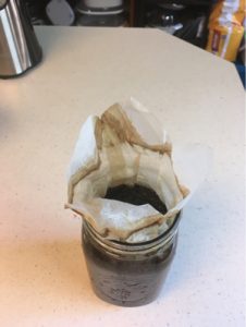 cold brew coffee in canning jar with filter folded up